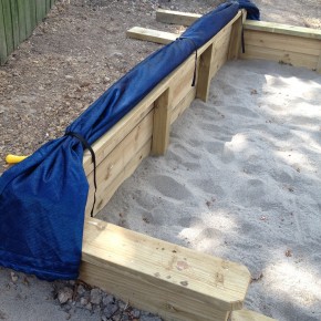 Weighted edge sand pit cover