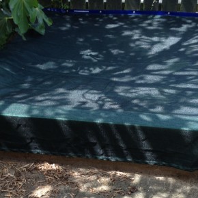 Weighted edge sand pit cover